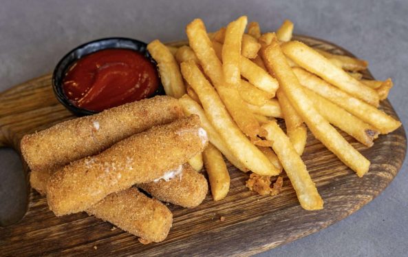 Kids mozzarella sticks with fries and tomato sauce on a board